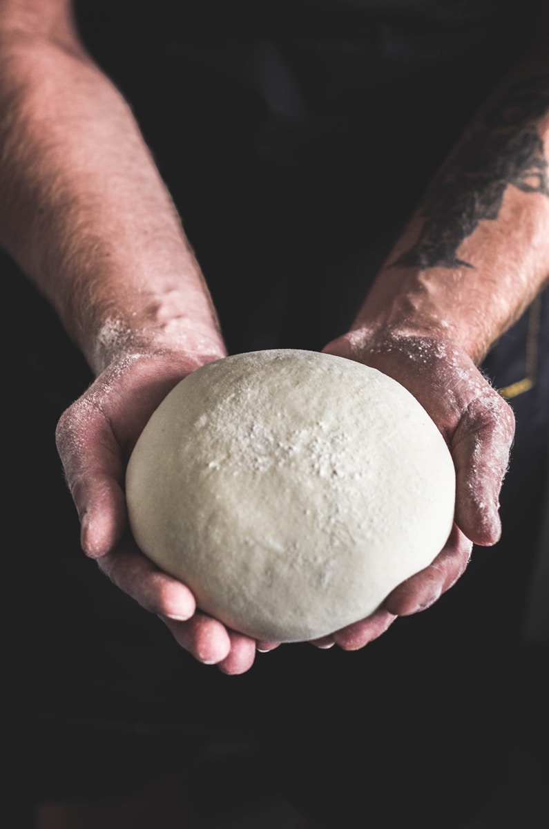 Photo by Arturrro person holding dough
