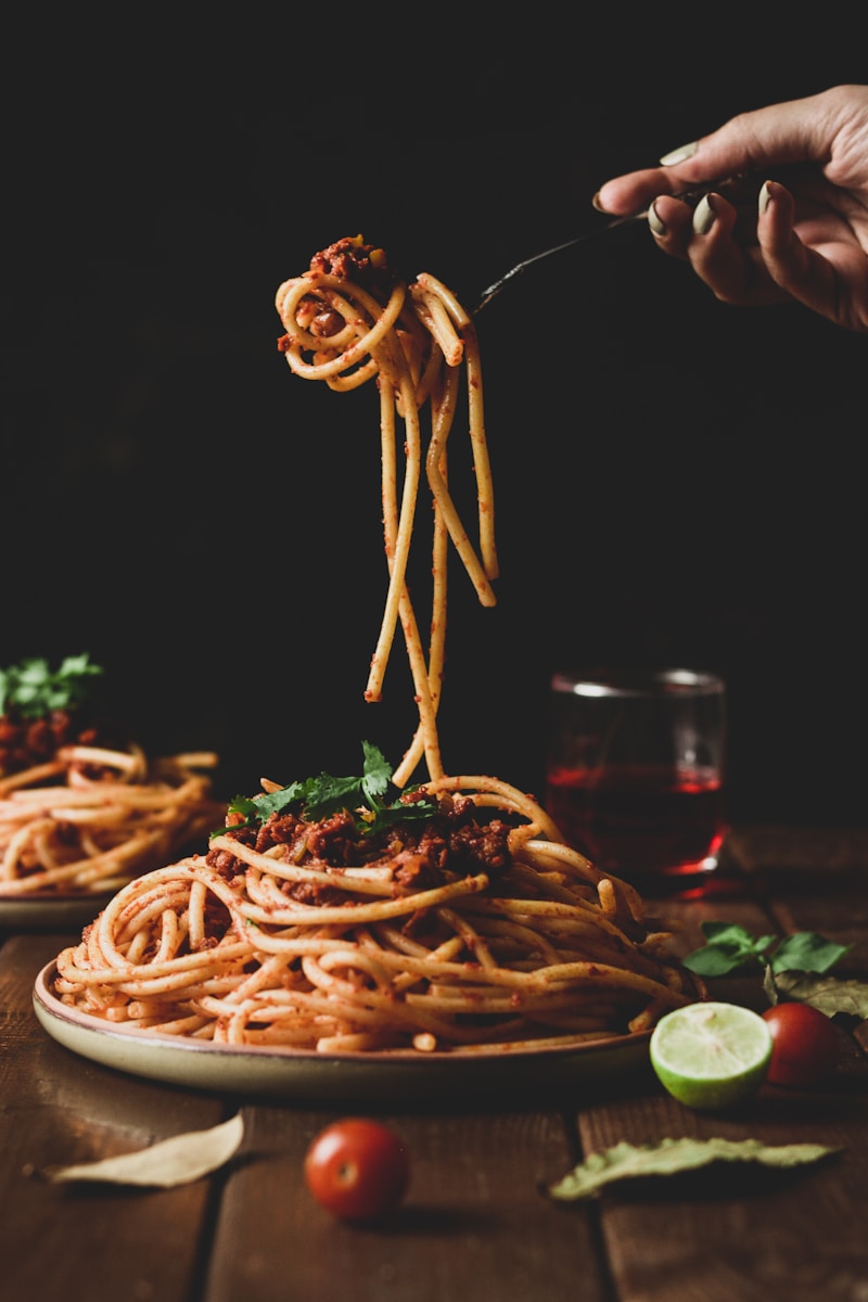 Photo by Atie Nabat pasta with green leaves on brown ceramic plate